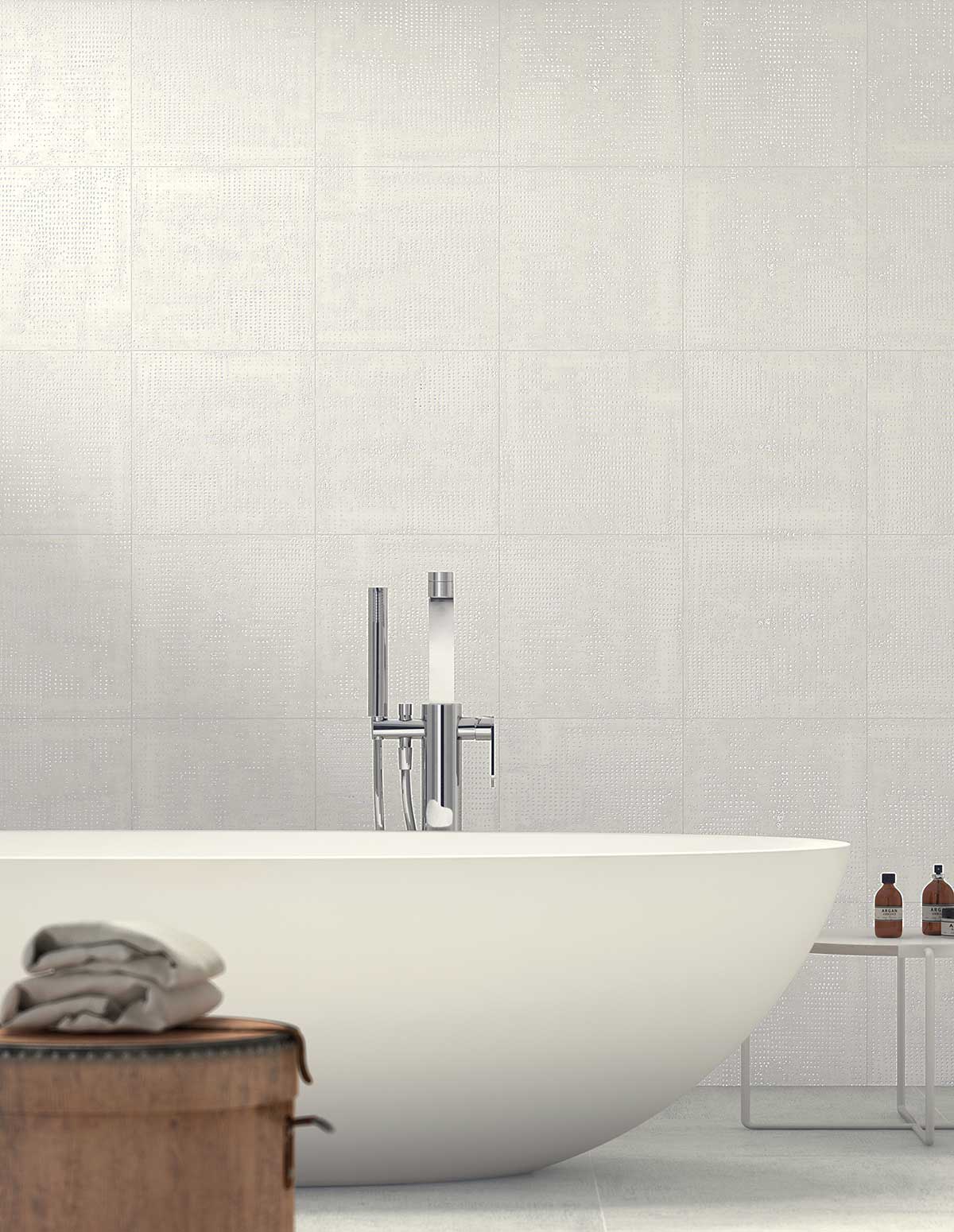modern bathtub with large wall tile behind