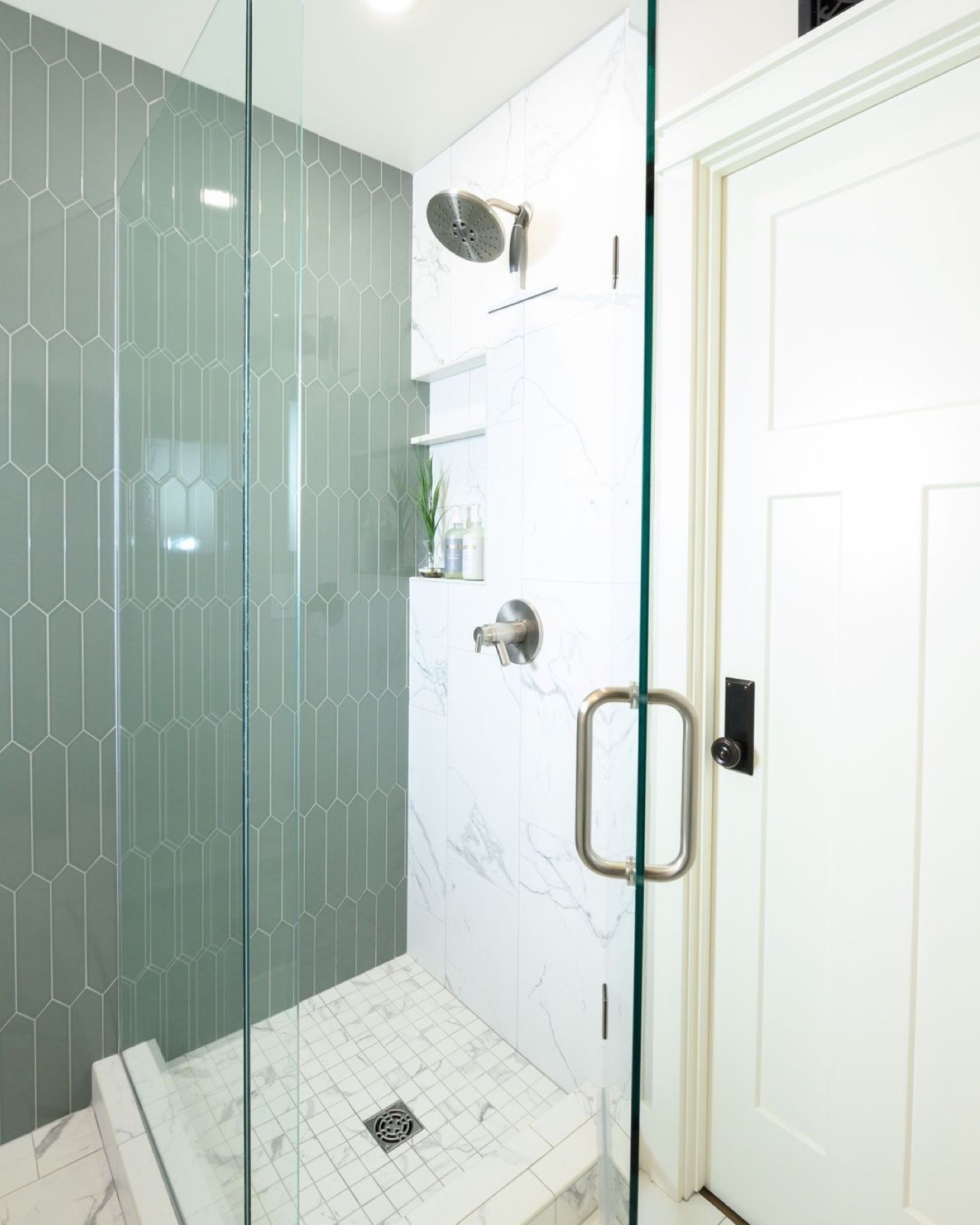 Accent wall with a contrasting tile in the shower looks both modern and adds a pop of color.